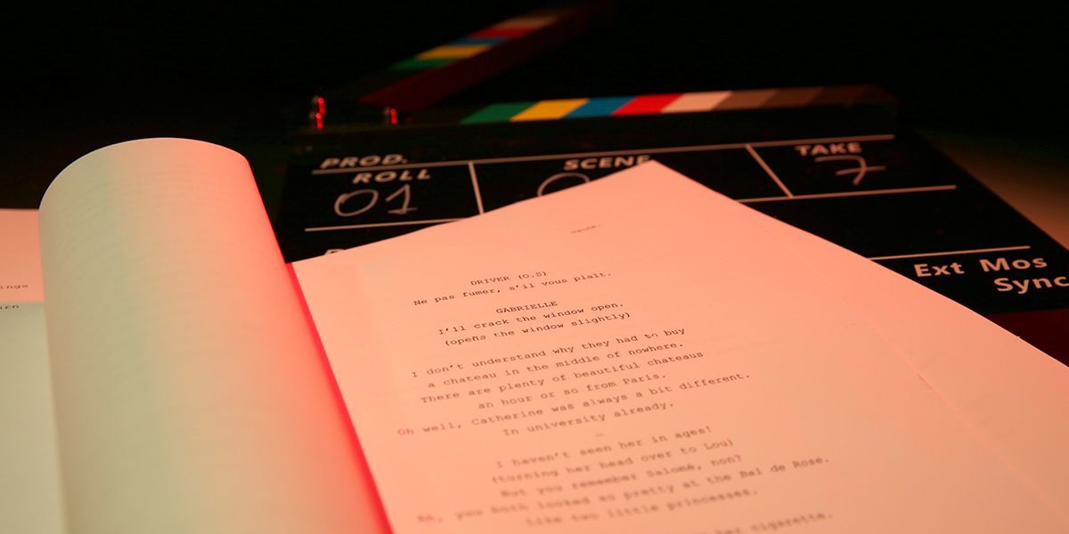 a man in a suit is talking to a woman in a blue dress