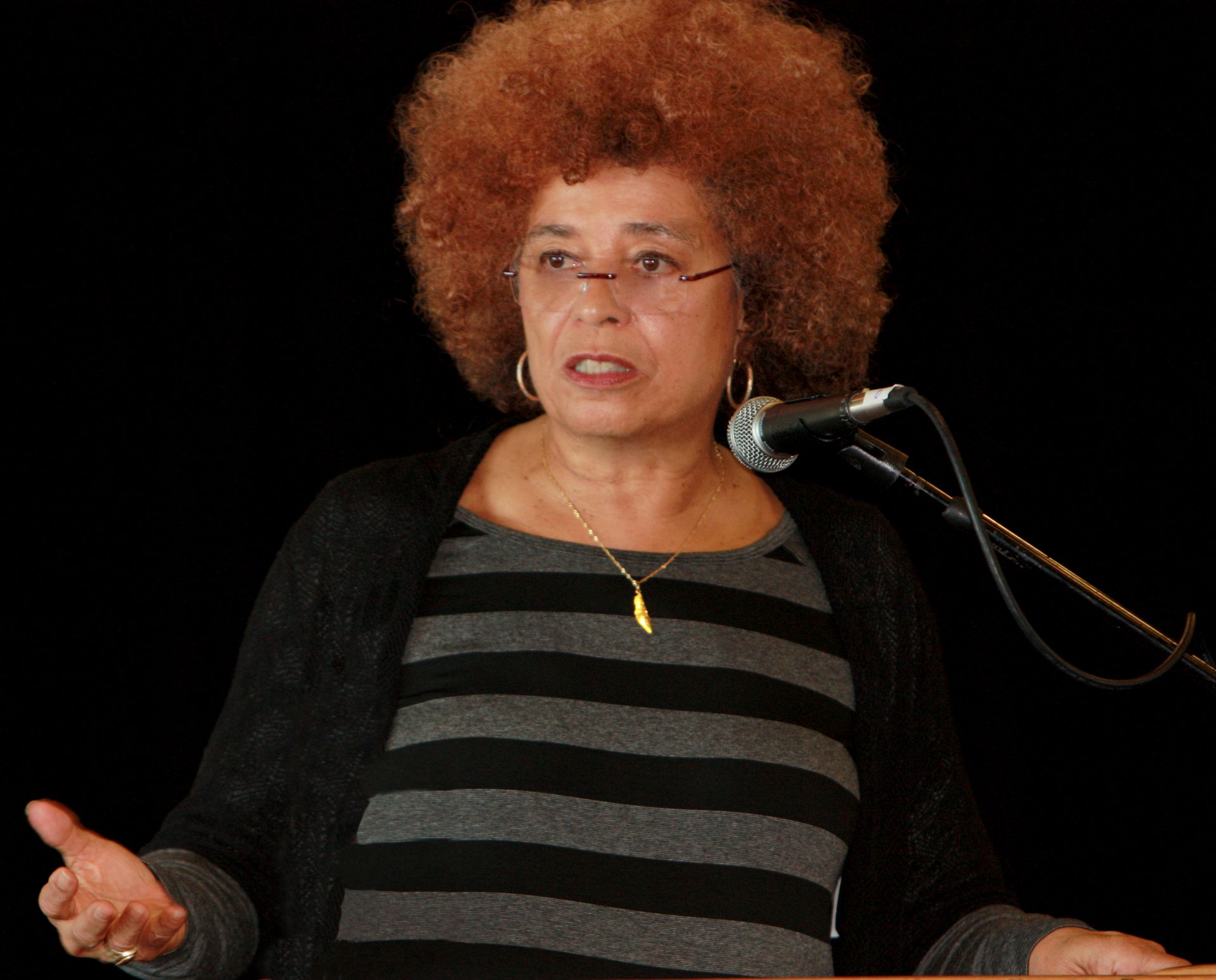 a woman with red hair is speaking into a microphone
