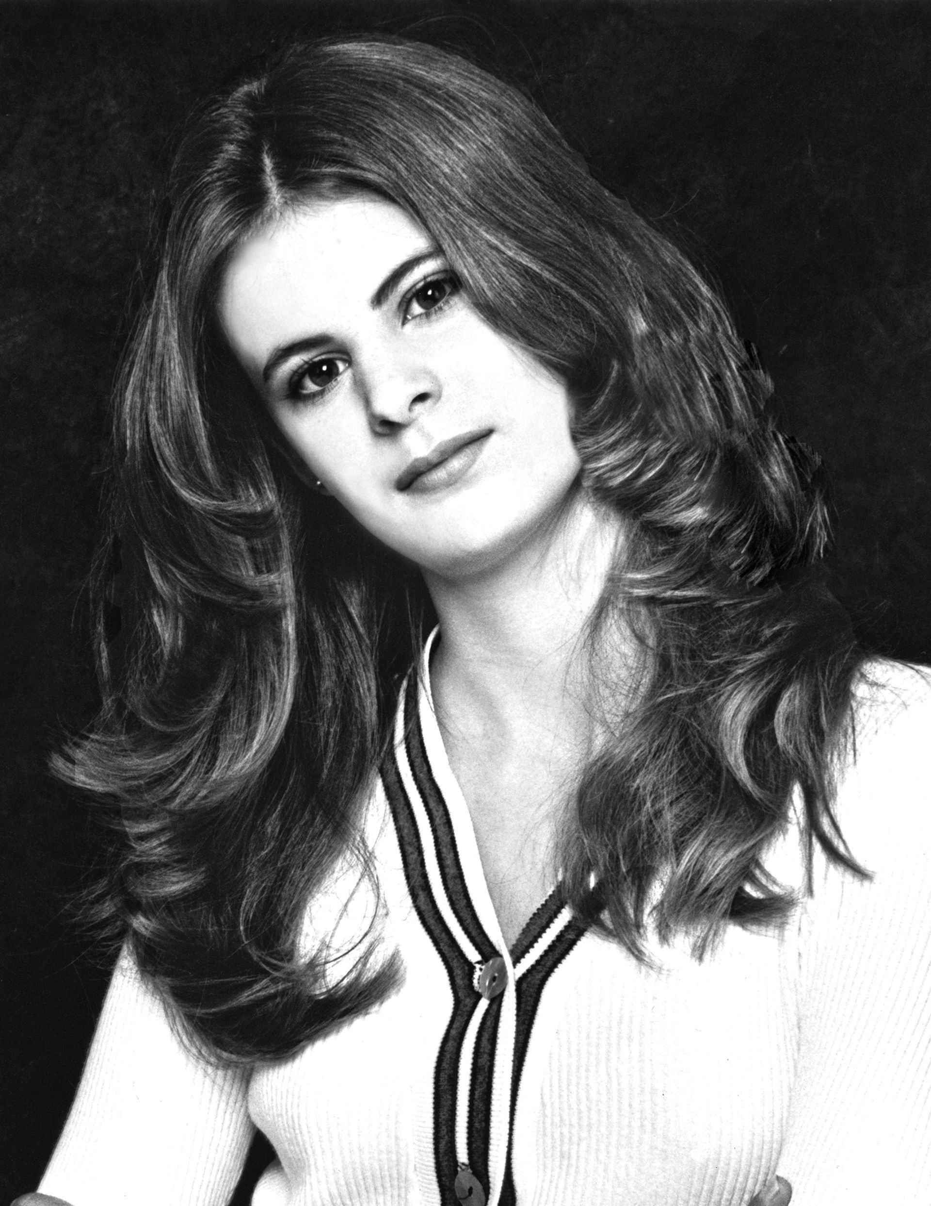 a black and white photo of a woman with long hair