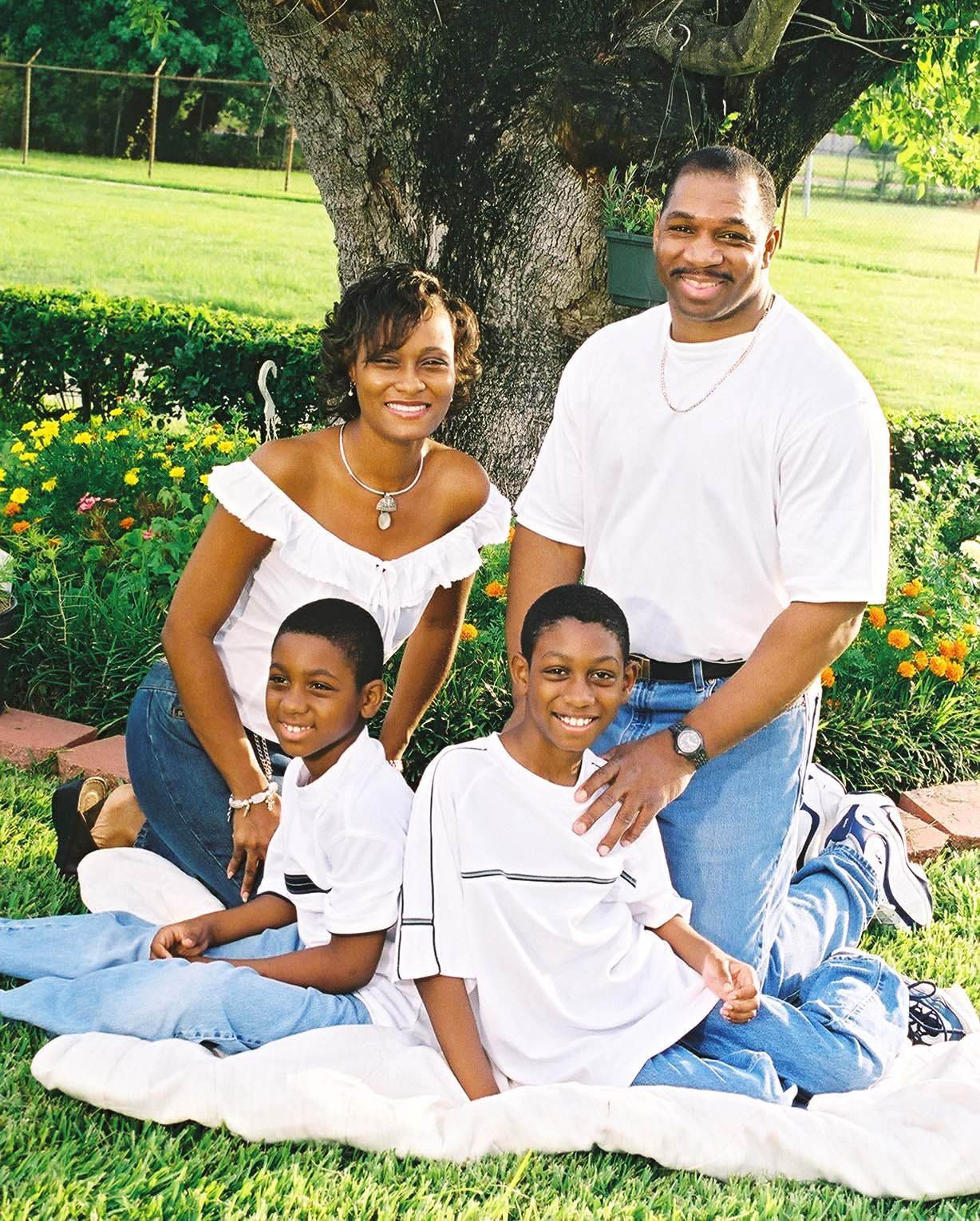 a family posing for a picture in the grass