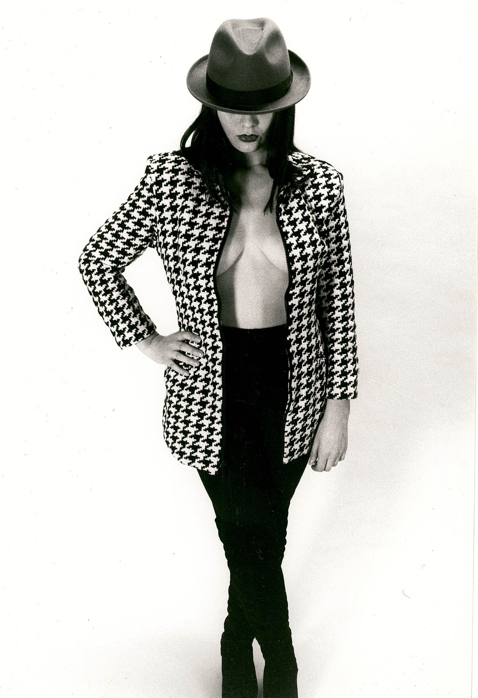 a black and white photo of a woman wearing a hat