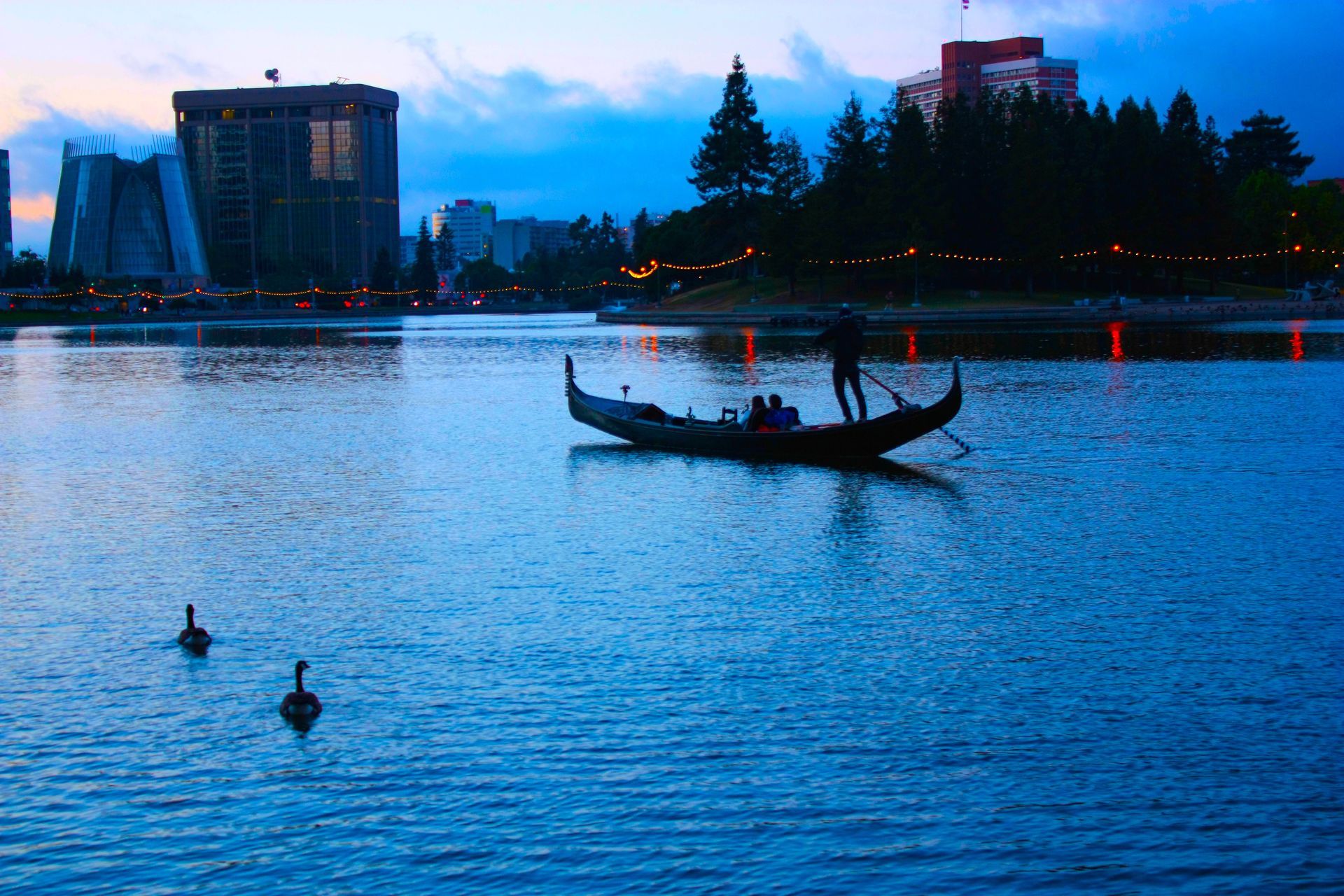 a man is riding a gondola on a lake