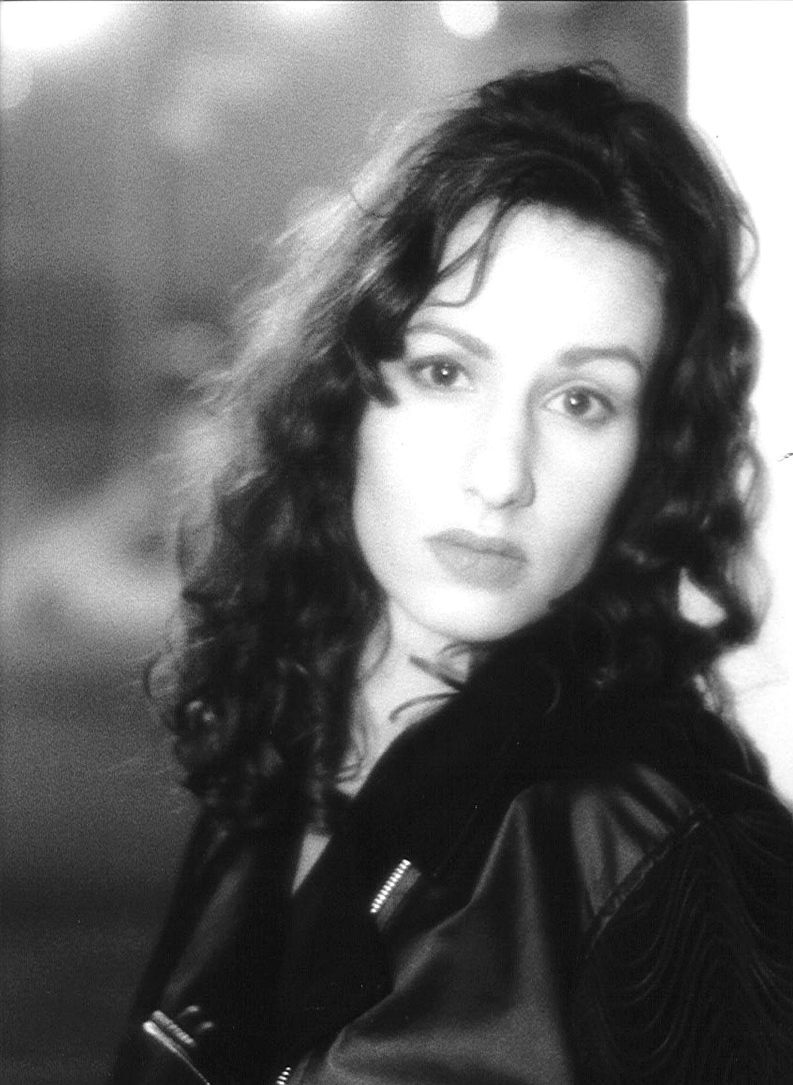 a black and white photo of a woman with curly hair