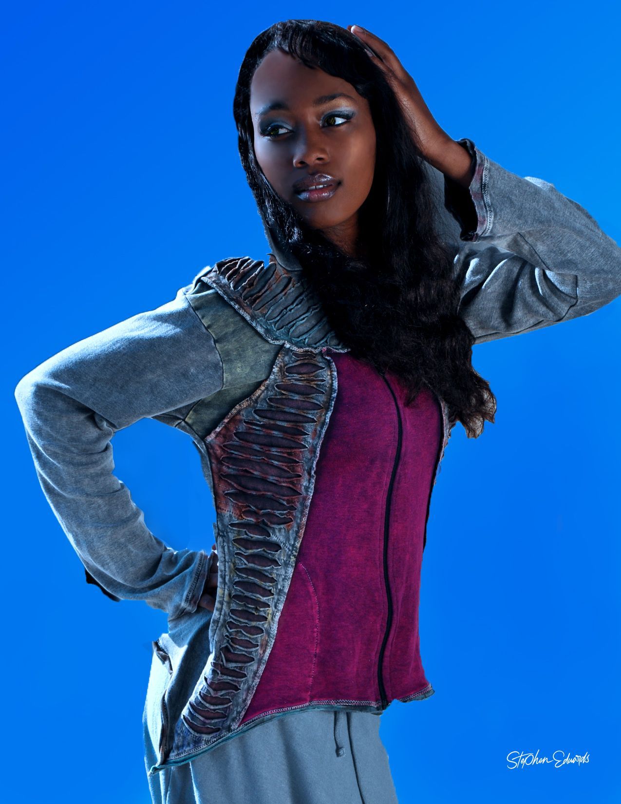 a woman is sitting on a couch holding a glass of wine