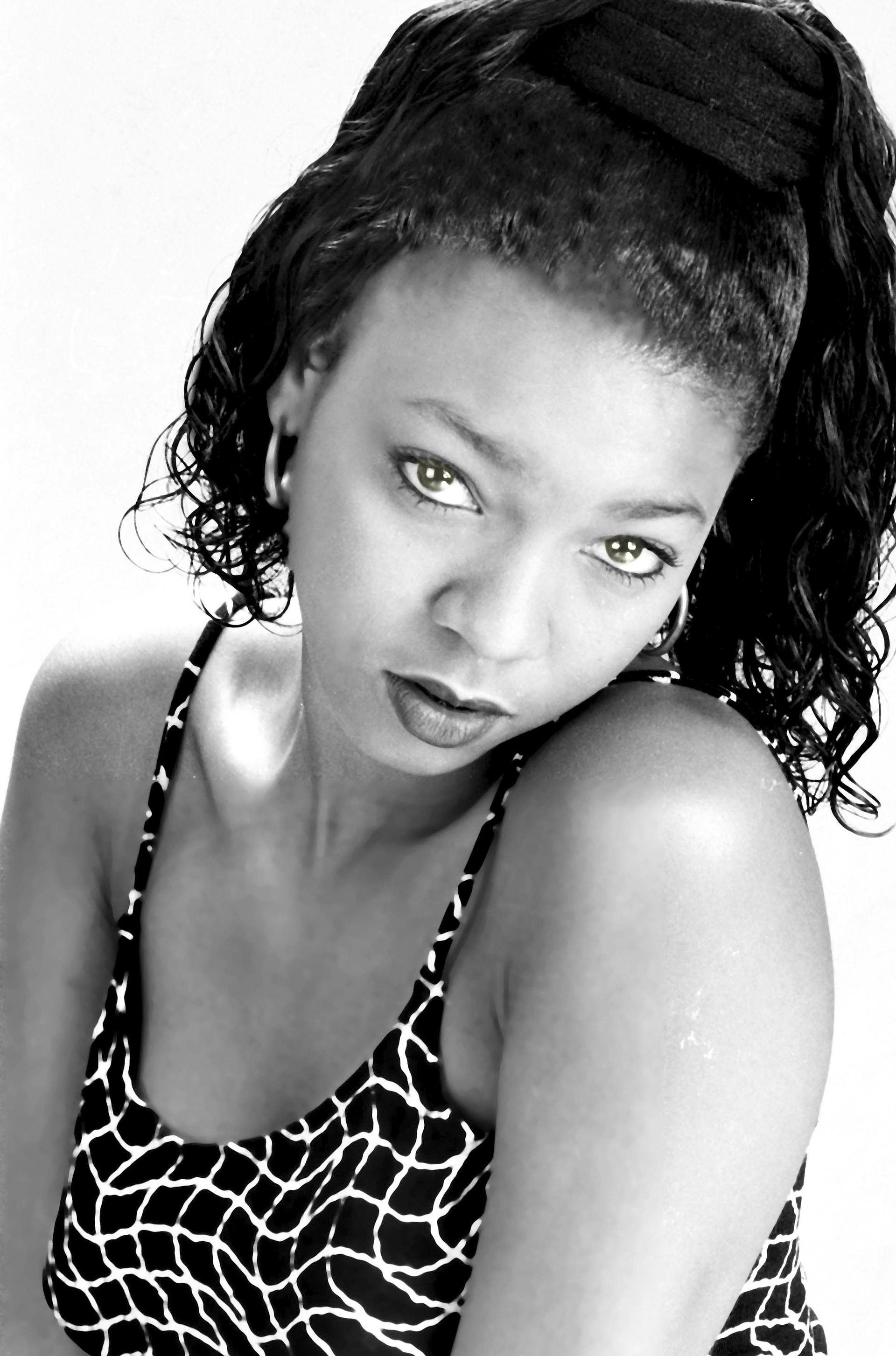 a black and white photo of a woman with a ponytail