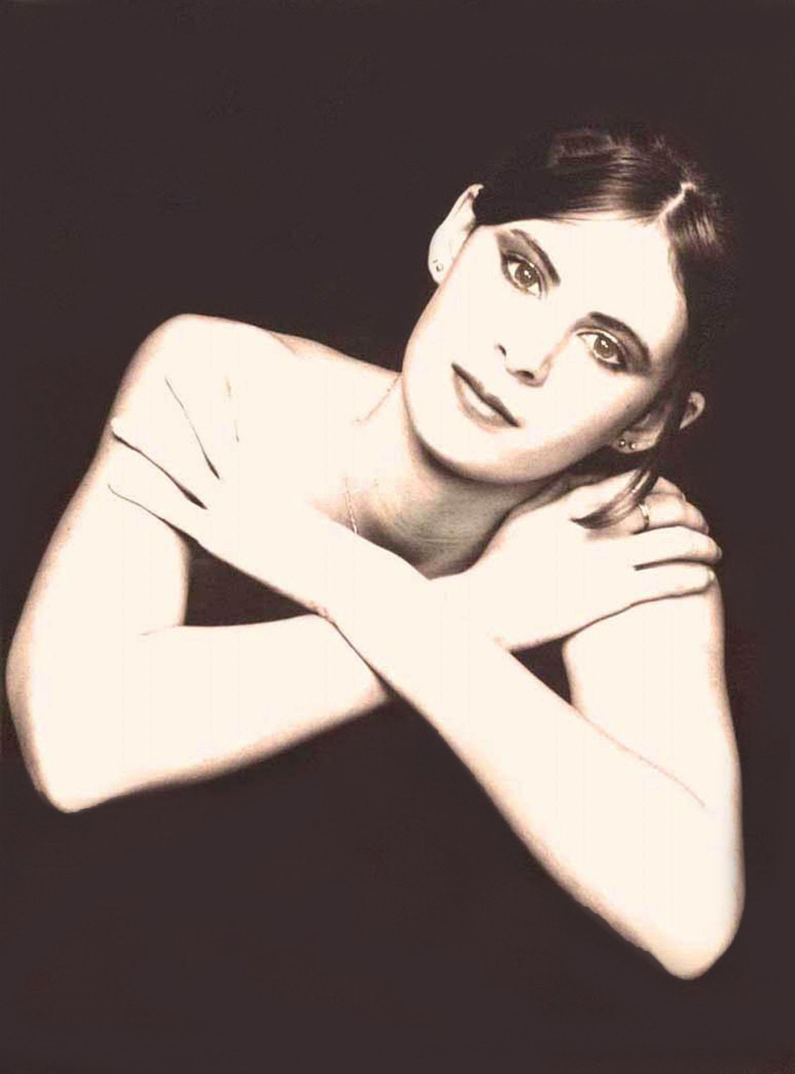 a black and white photo of a woman with her arms crossed