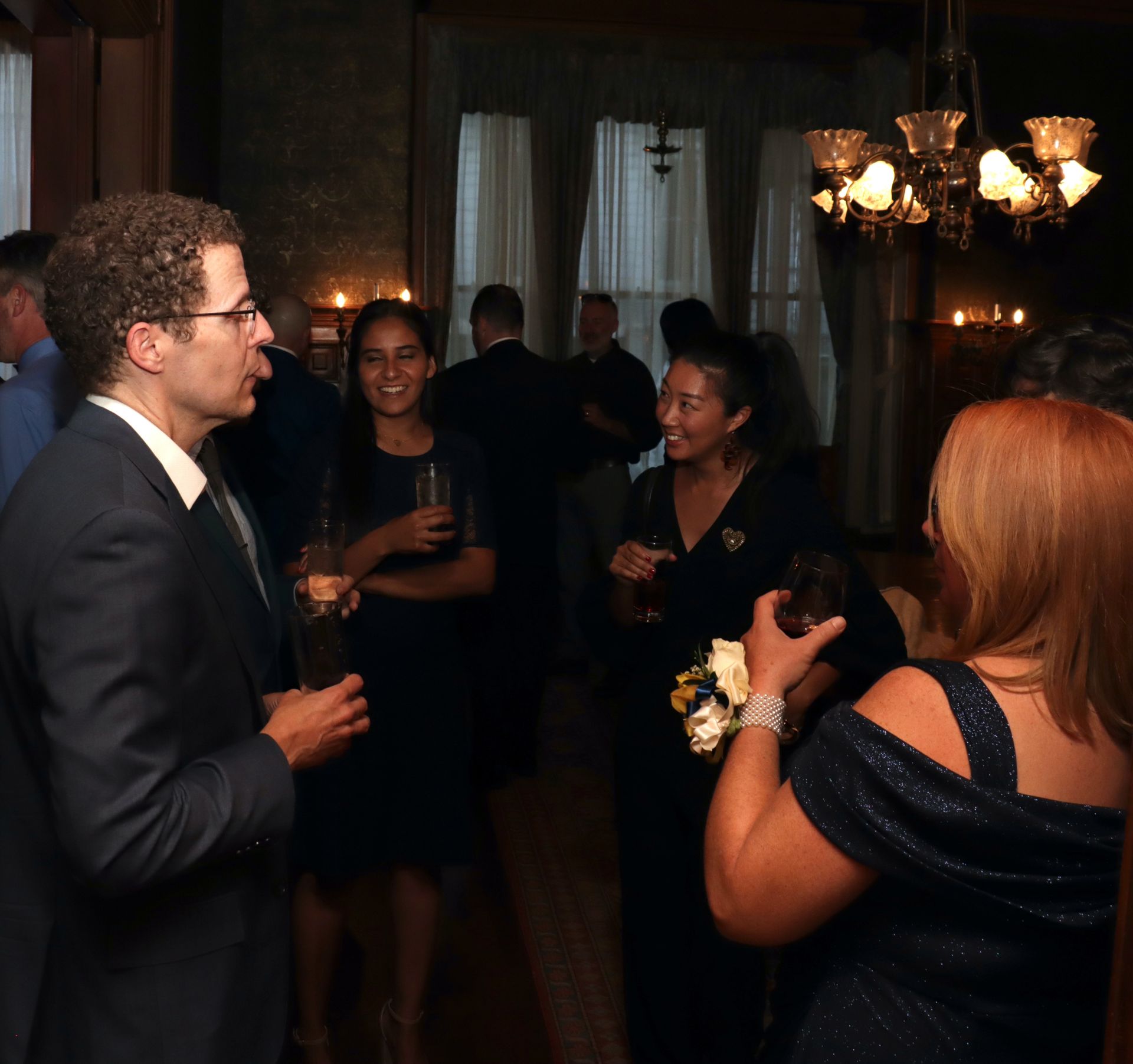 a man in a suit is talking to a woman in a blue dress