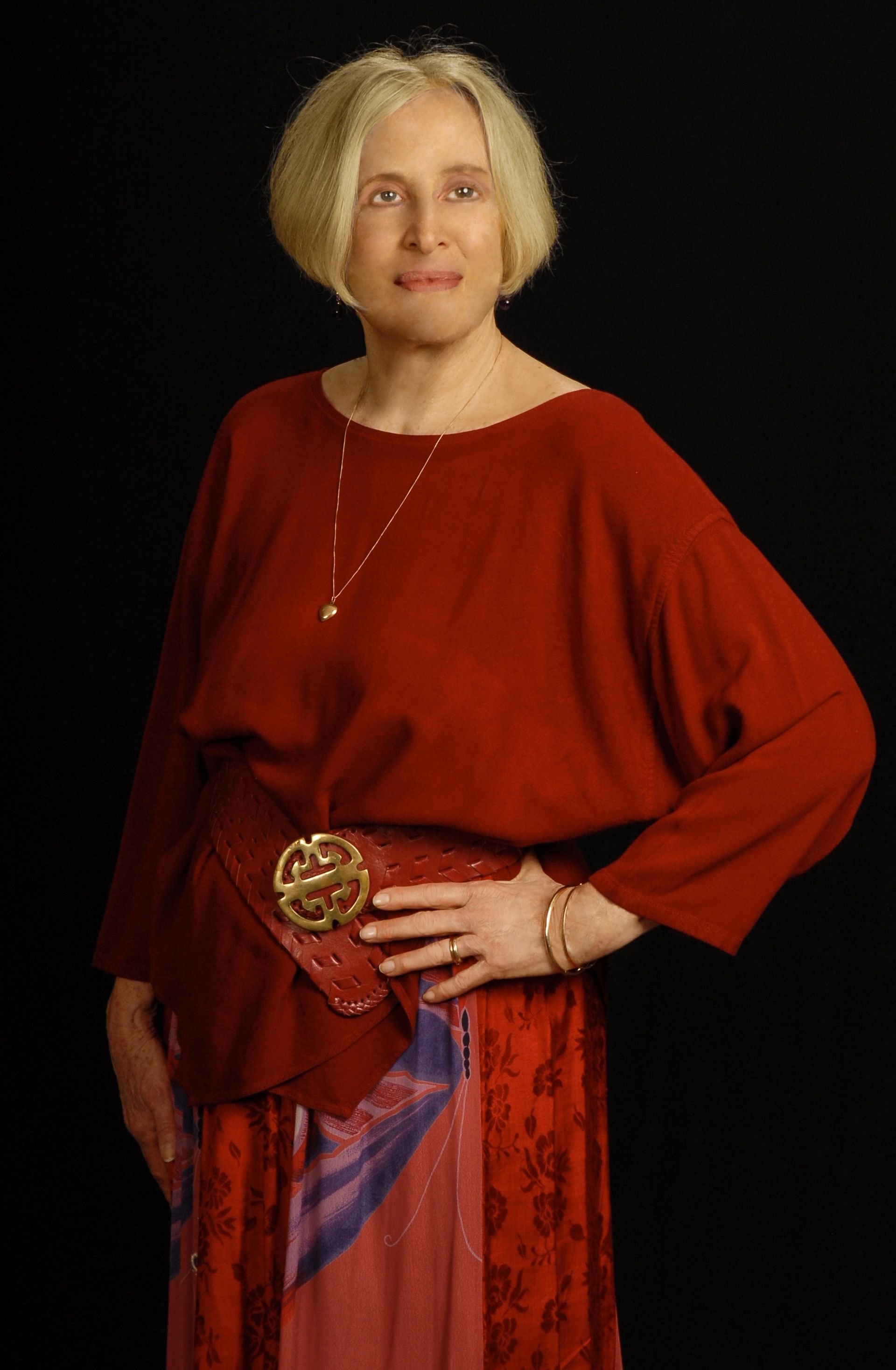 a woman is wearing a red top and a red skirt