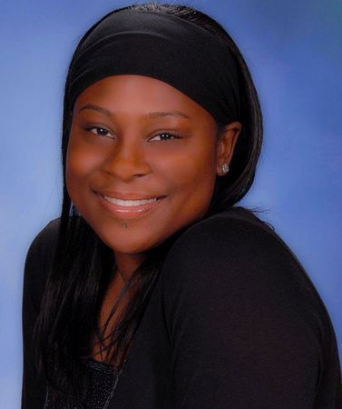 a woman wearing a black headband smiles for the camera