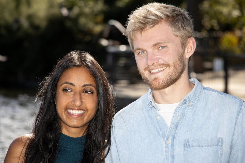 a man and a woman are standing next to each other and smiling .