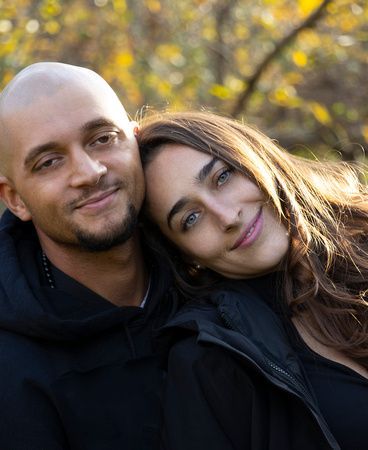 a man and a woman are posing for a picture together .