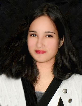 a woman with long dark hair is wearing a white jacket and black belt .