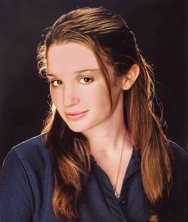 a woman with long brown hair is wearing a blue shirt