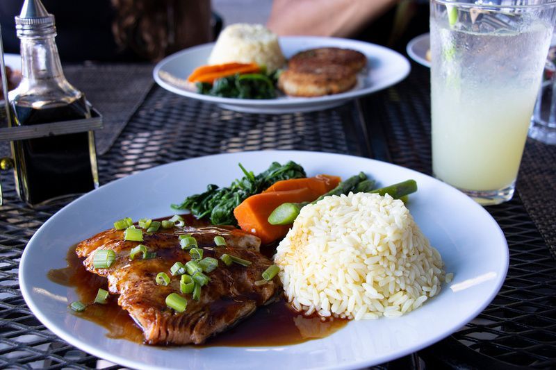 a plate of food with rice and vegetables on a table