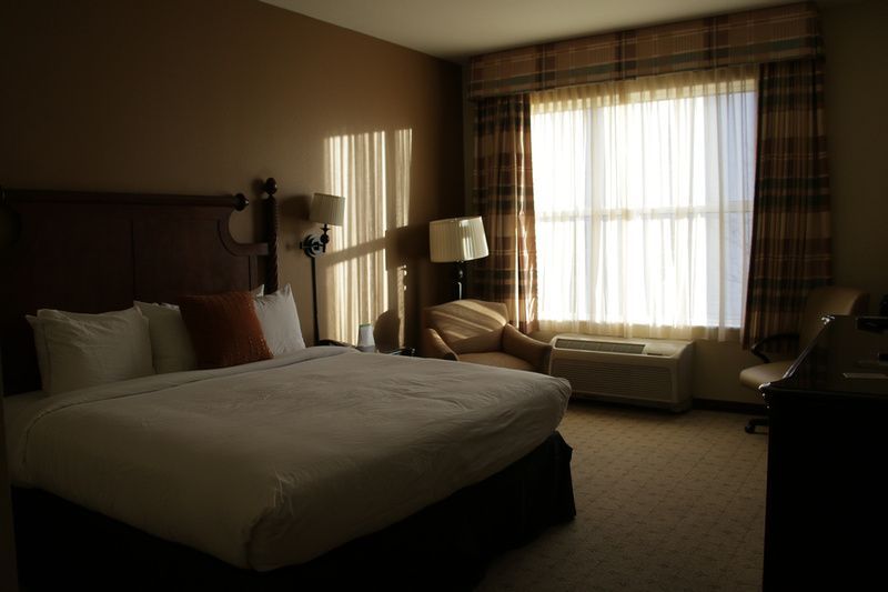 a hotel room with a king size bed and a large window