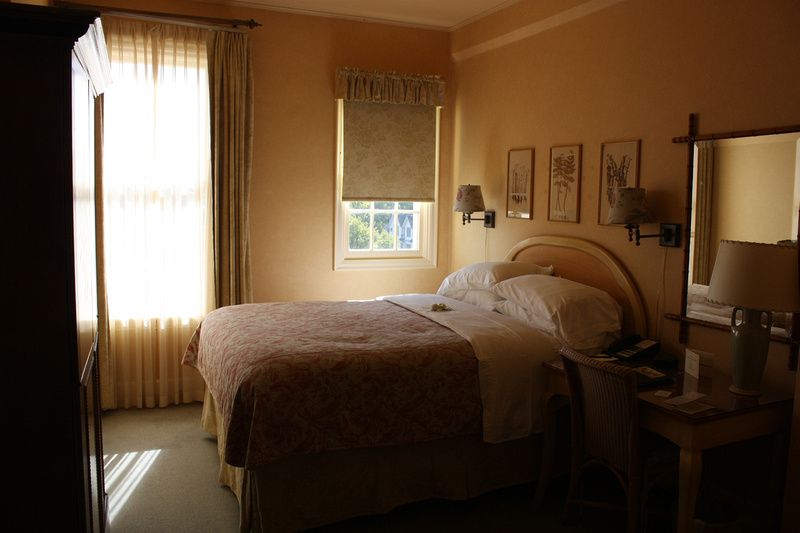 a hotel room with a bed and a window