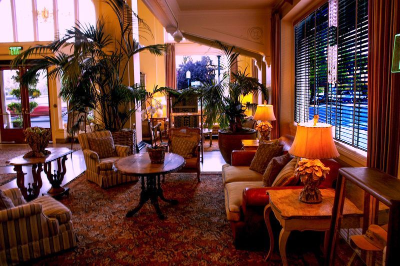 a living room with lots of furniture and a green exit sign