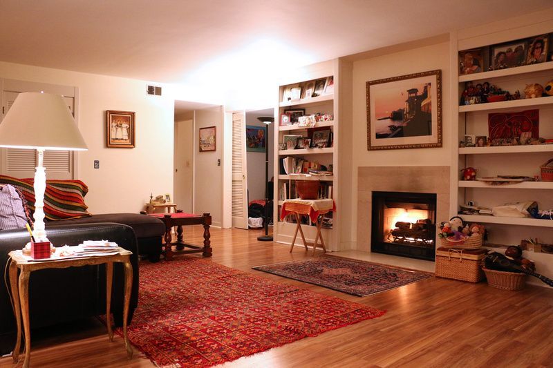 a living room with a fireplace and a lamp