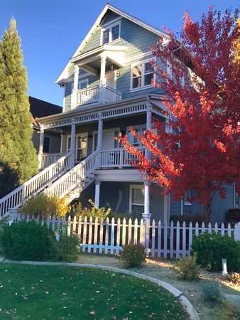 a large house with a white picket fence in front of it .
