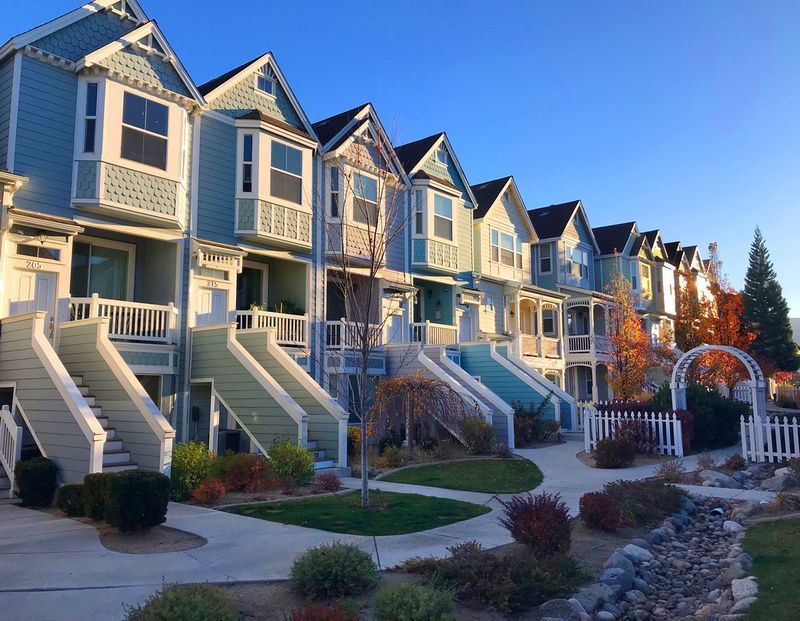 a row of houses with stairs leading up to them