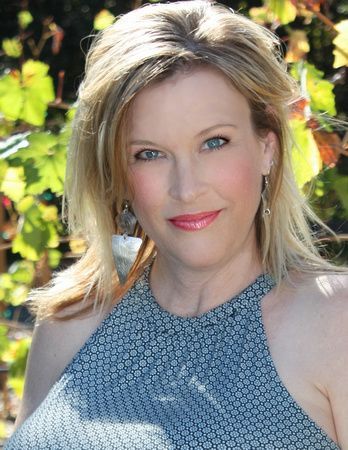 a woman in a blue halter top is smiling for the camera .