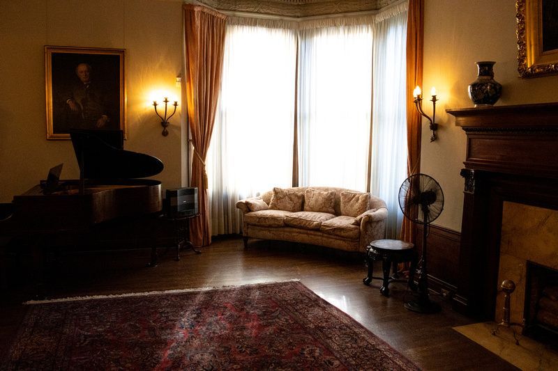 a living room with a piano and a couch