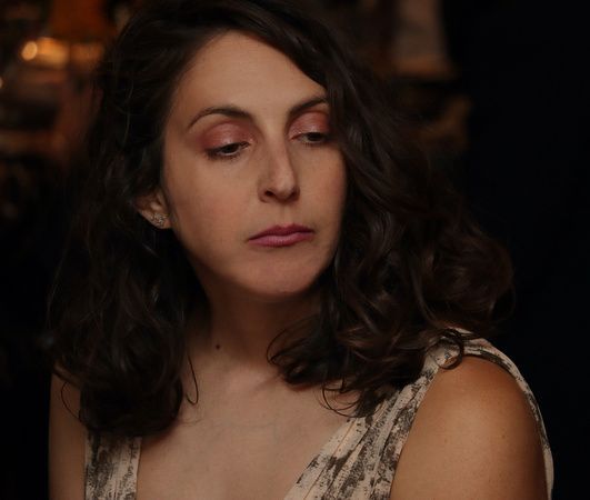 a close up of a woman 's face with her eyes closed