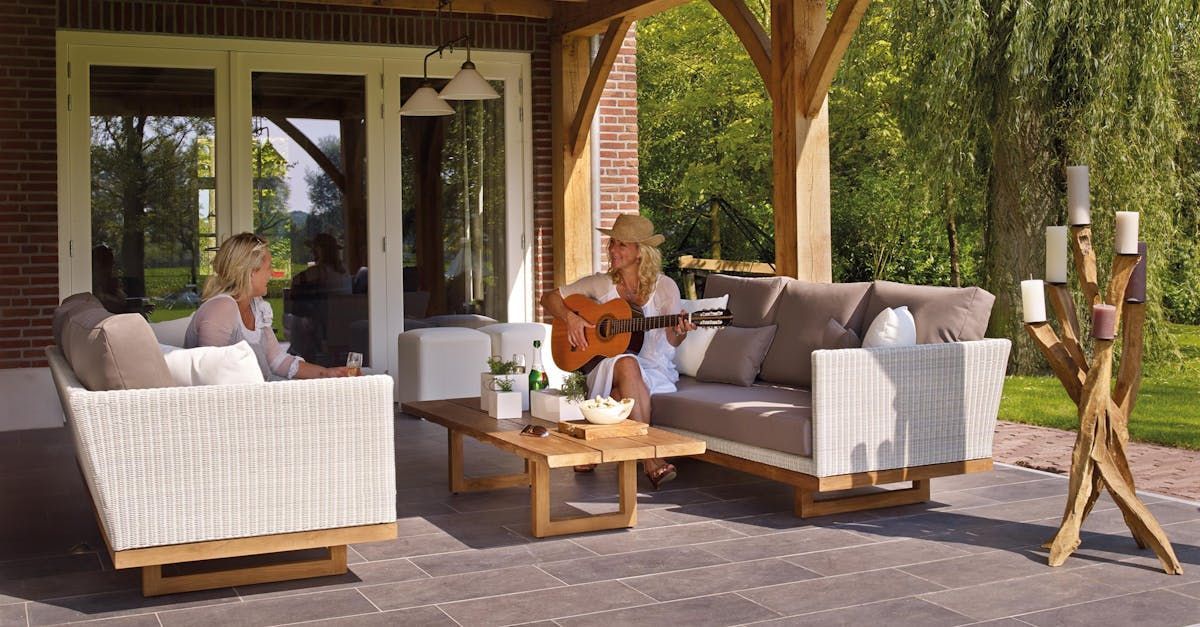 Women chatting while playing guitar in their outdoor space