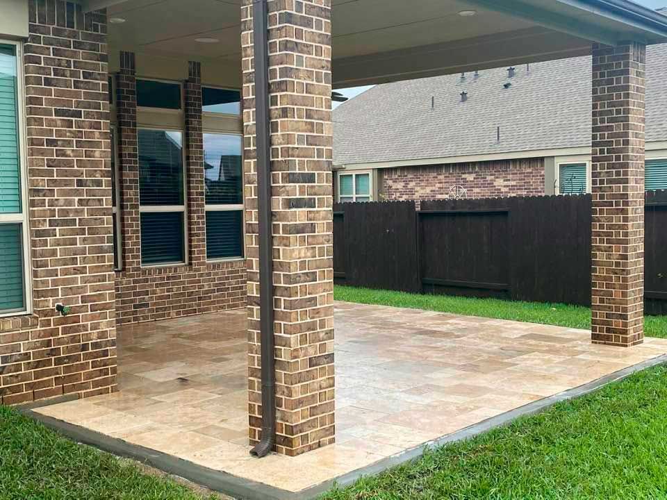 Covered small glossy limestone patio