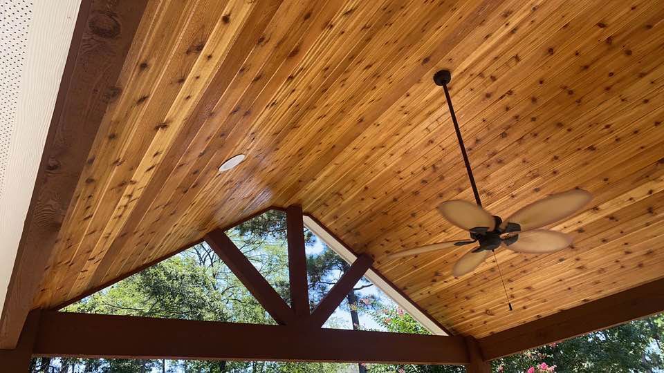 Wooden gable patio roofing with a blade fan