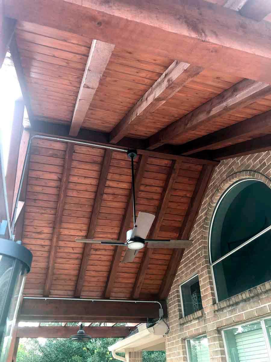 Wooden gable patio cover with blade fan