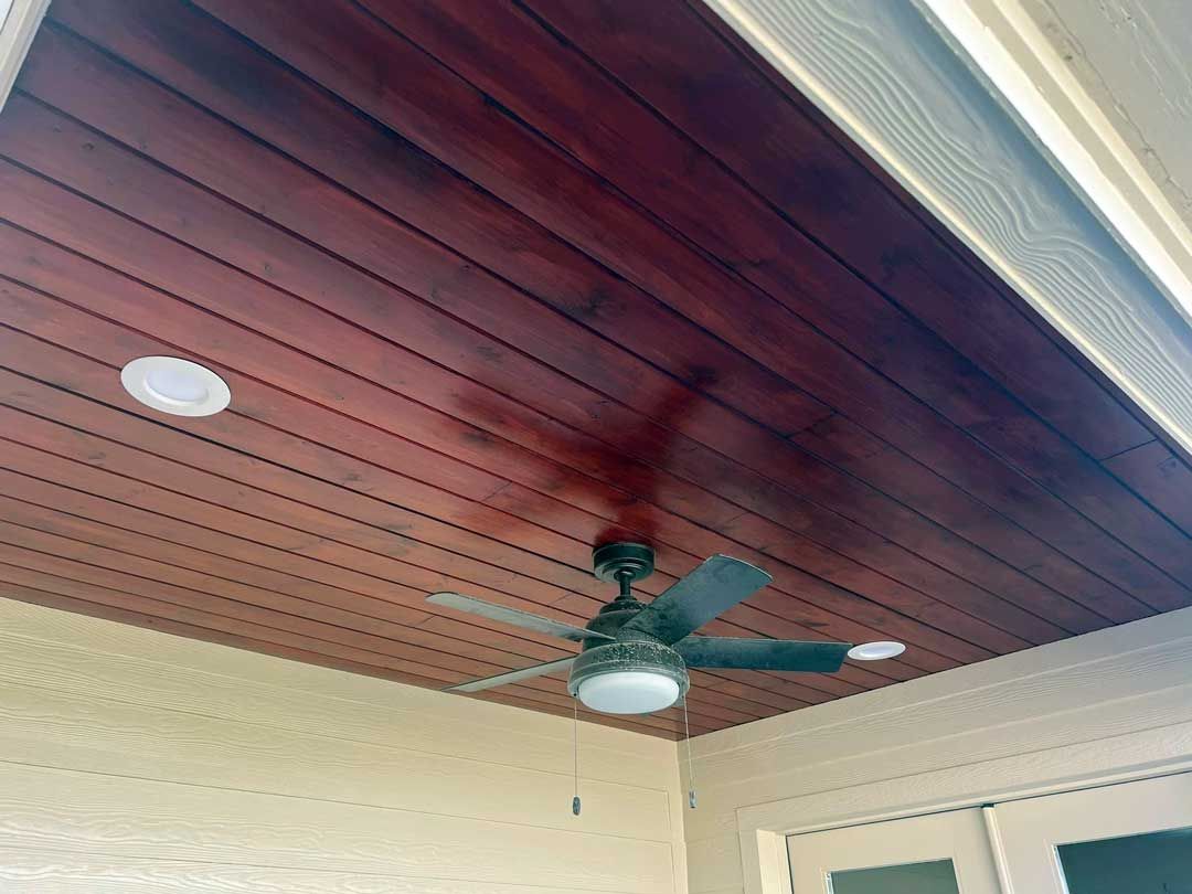 Cedar-covered ceiling with blade fan