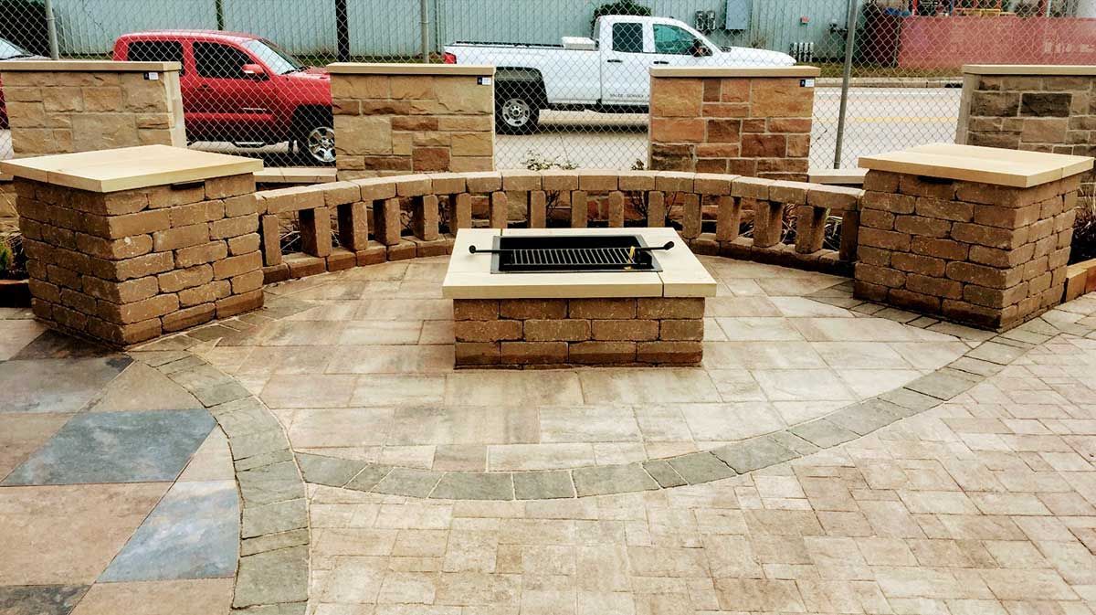 Beautiful limestone outdoor patio with a square gas fire pit