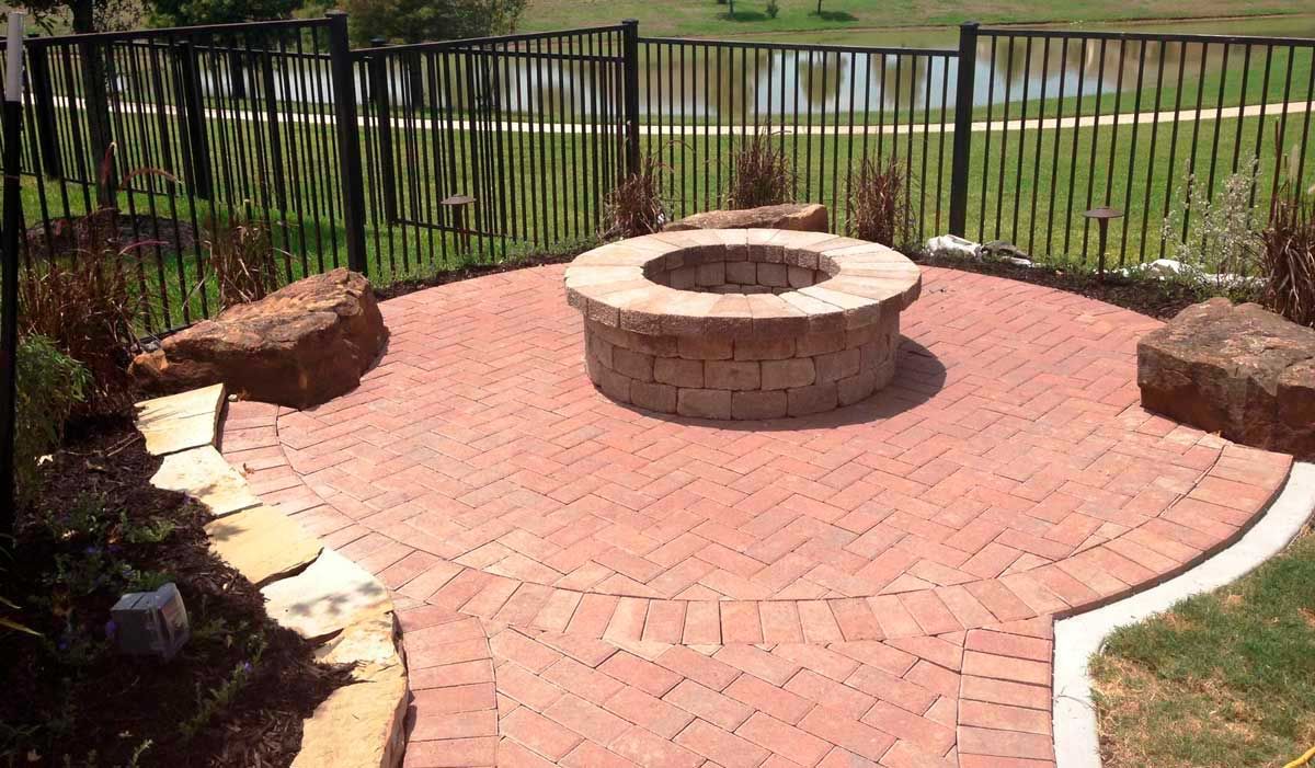 Circular red brick patio with fire pit for burning firewood