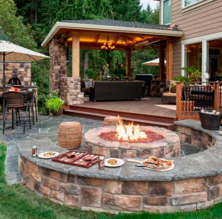 Elegant covered patio with fire pit and barbecue area