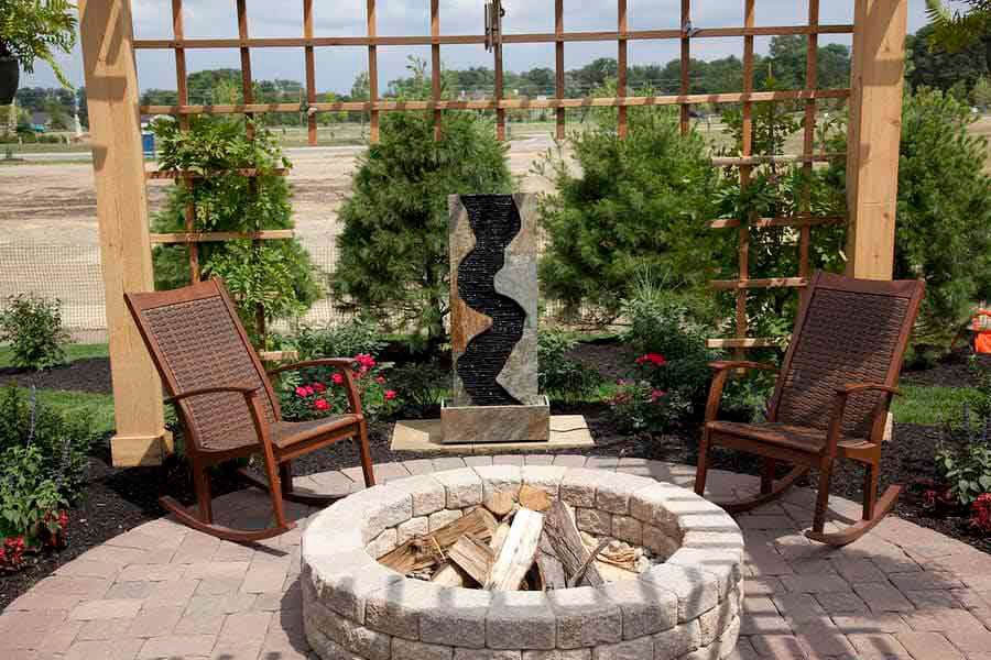 Custom fire pit with landscaping and paver patio