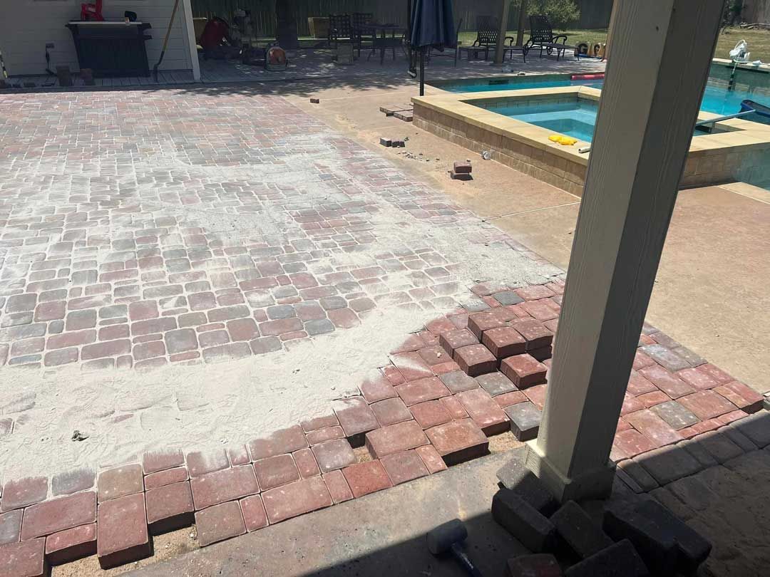 Red-toned brick patio polymeric sand application