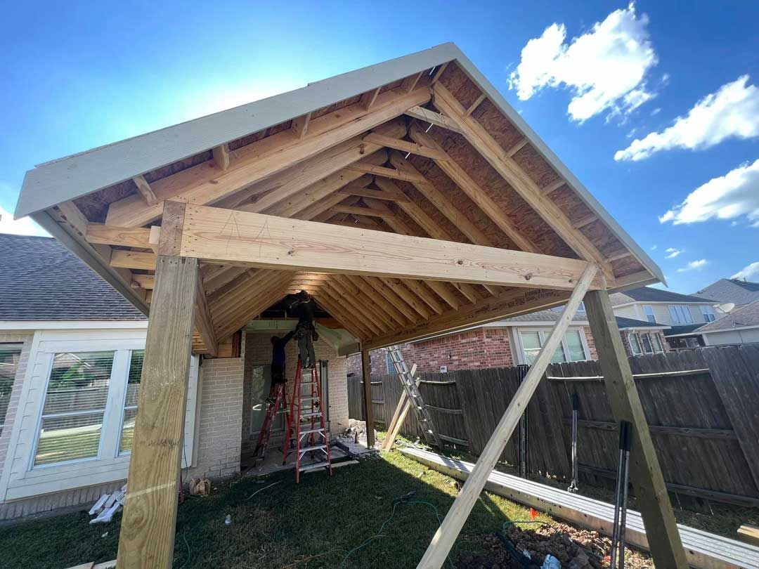 A ceiling fan installation and wooden patio cover construction detail