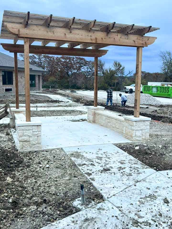 Installation of a  wooden pergola on a new cement patio