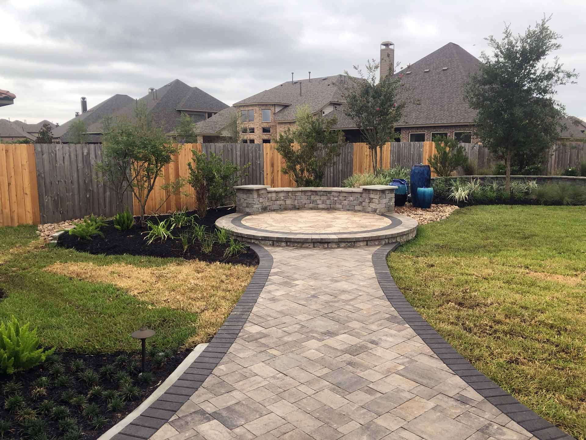Wide paver pathway with a paver circular patio at the end