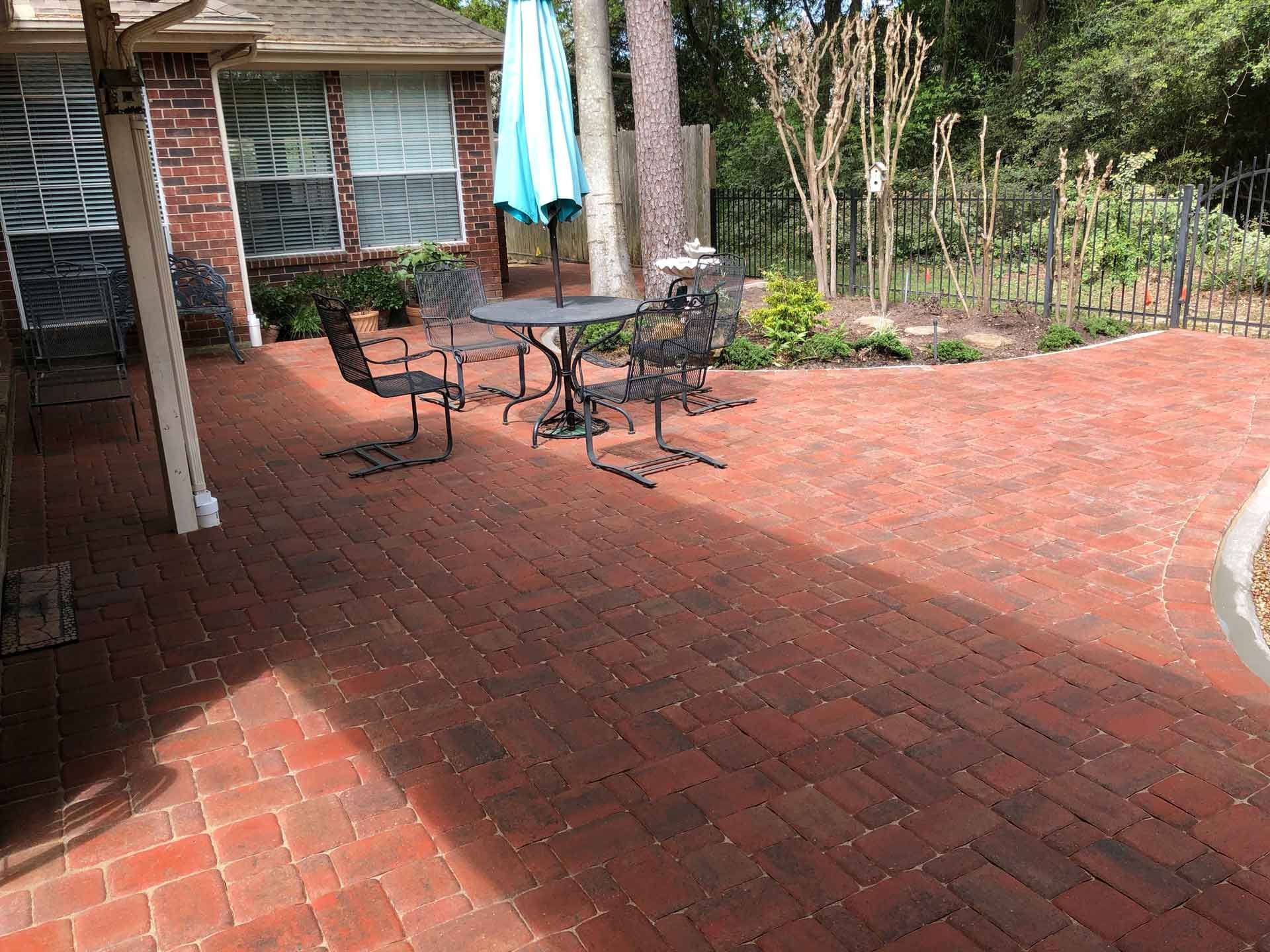 Red stone paver patio with landscaping