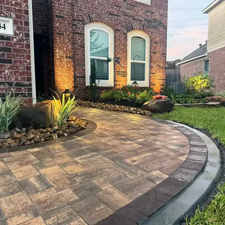 A brick house with a brick walkway in front of it.