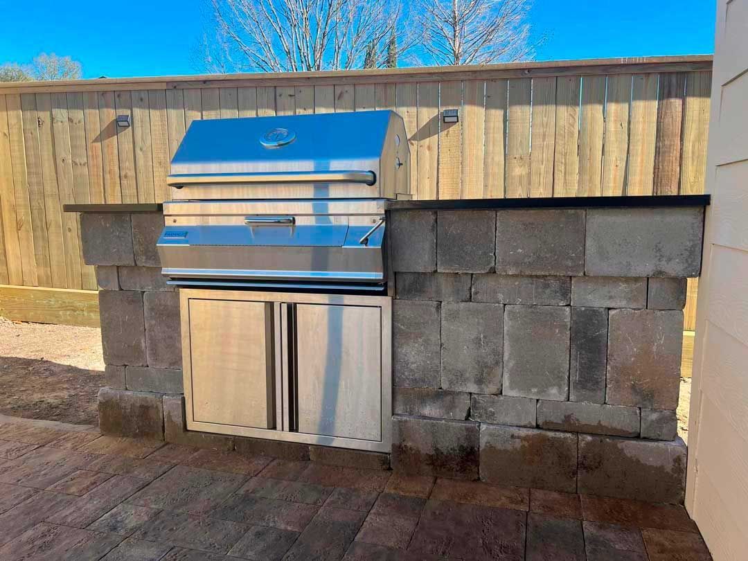 Outdoor stoned kitchen with stainless steel cover