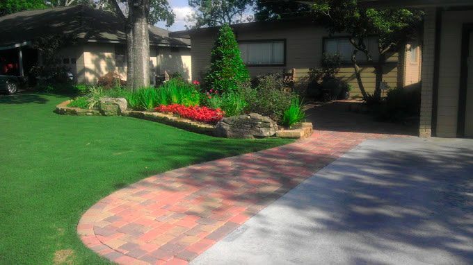 Landscaping with red flowers and shrubs for appeal
