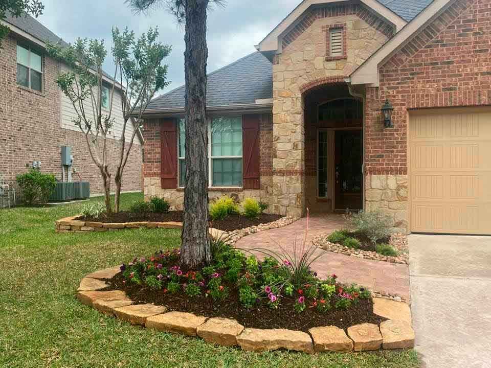 Nice set of circular stone landscaping with flowers and tree