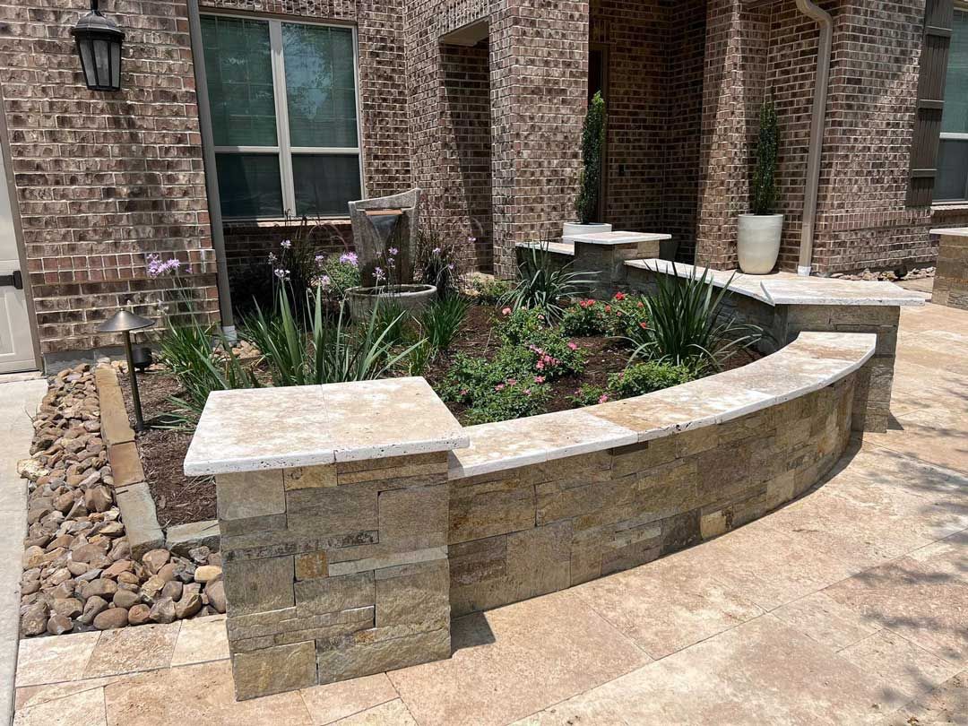 Landscaping with plants and flowers and limestone and marble tile walls