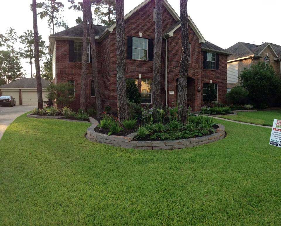 Elegant circular design of landscaping bed with trees surrounded by grass