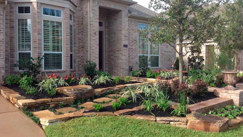Stone landscaping beds with plants for curb appeal