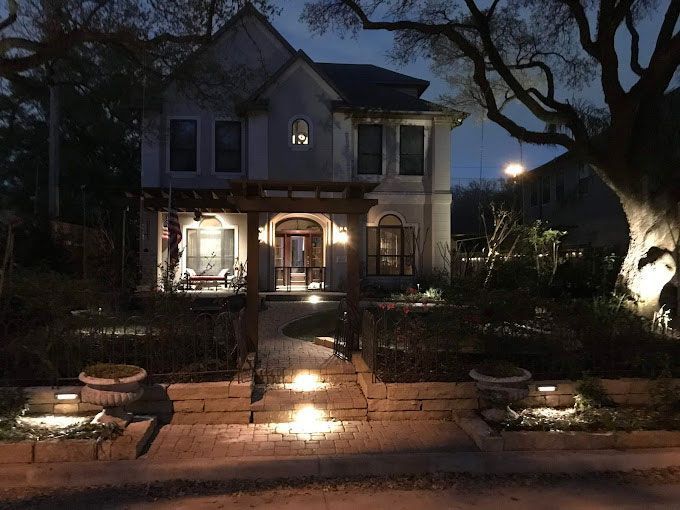 Residential front yard with outdoor lighting and pavers pathways