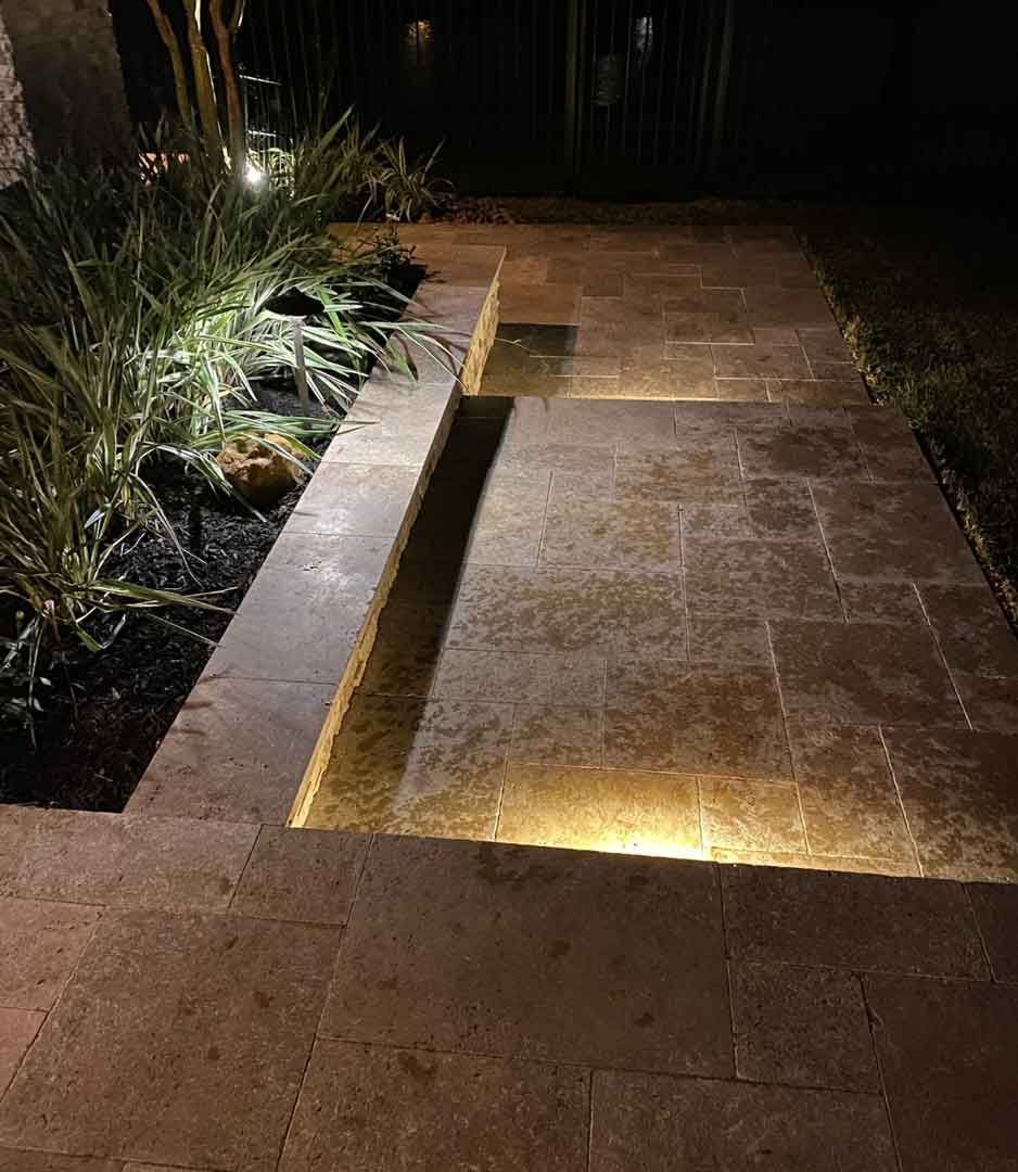 Bright limestone walkway with lighted staircase